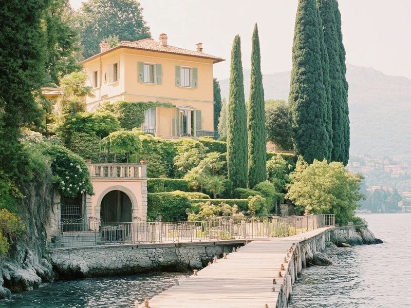 A lakeside villa among cypress trees with a private wooden pier